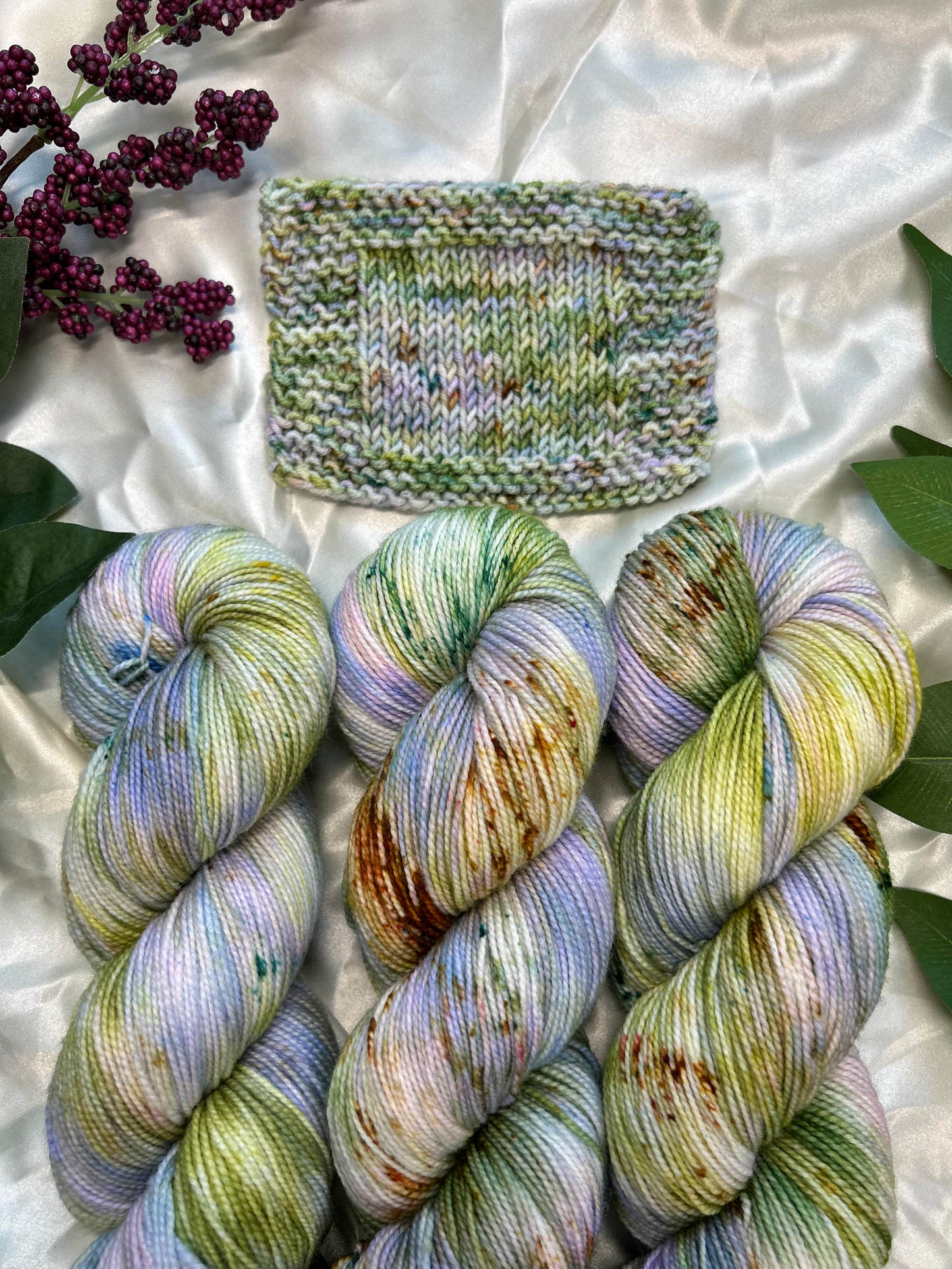 custom lilac, green, dark green, gold variegated hand dyed yarn with forest green and fawn brown speckles on nylon superwash sock weight