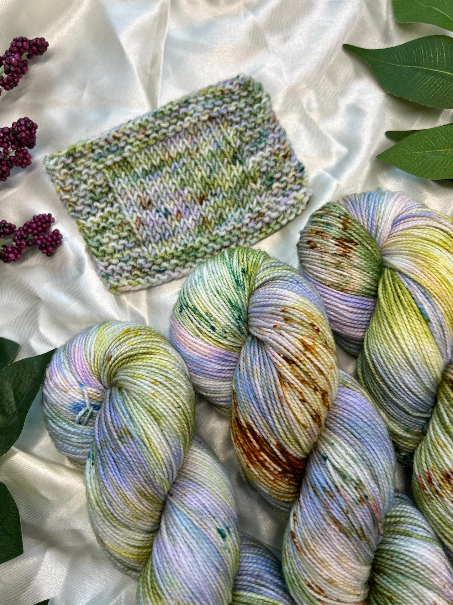 custom lilac, green, dark green, gold variegated hand dyed yarn with forest green and fawn brown speckles on nylon superwash sock weight