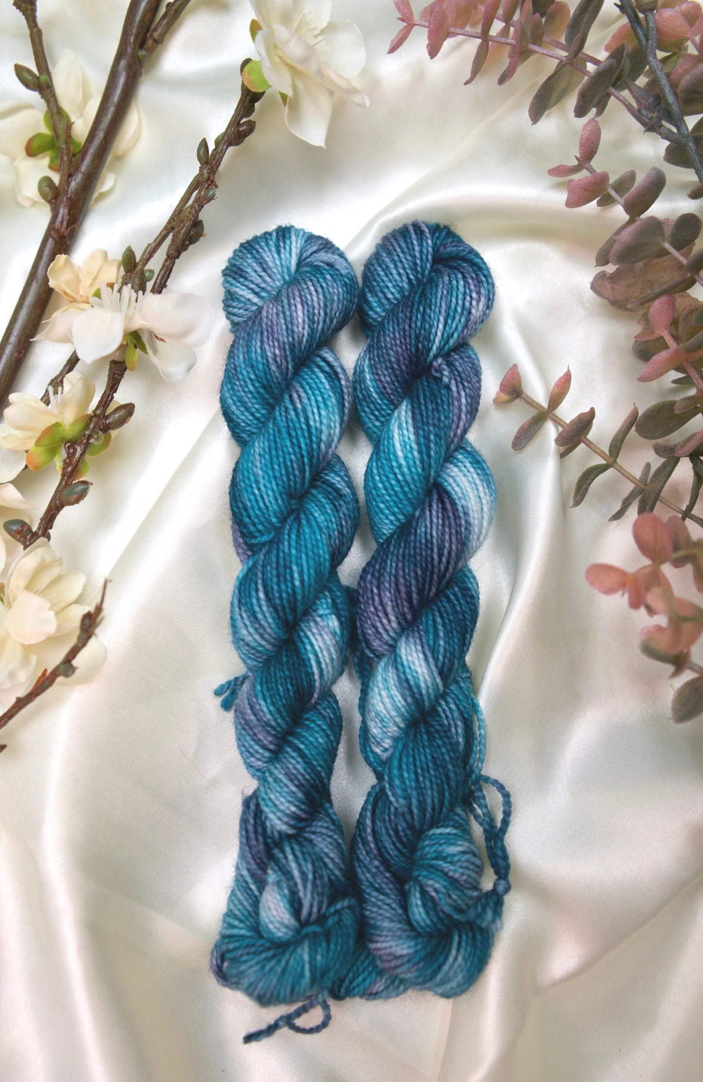 custom variegated hand dyed yarn with teal, deep blue and white on nylon superwash sock weight