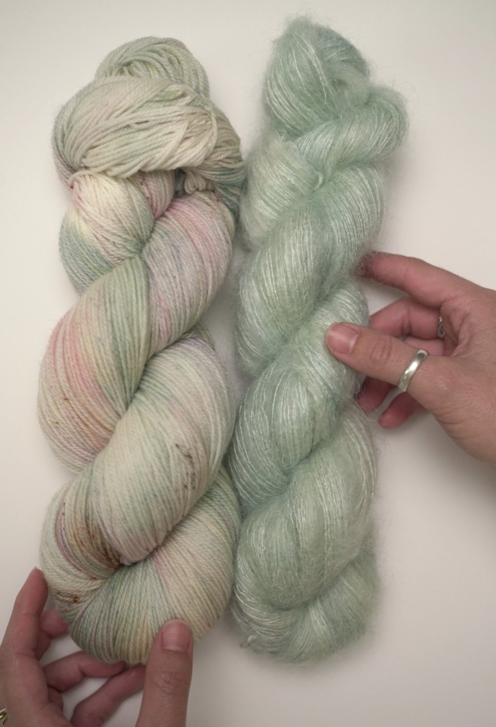 buddha hand dyed yarn colorway on mohair paired next to garden party hand dyed yarn on superwash fingering weight