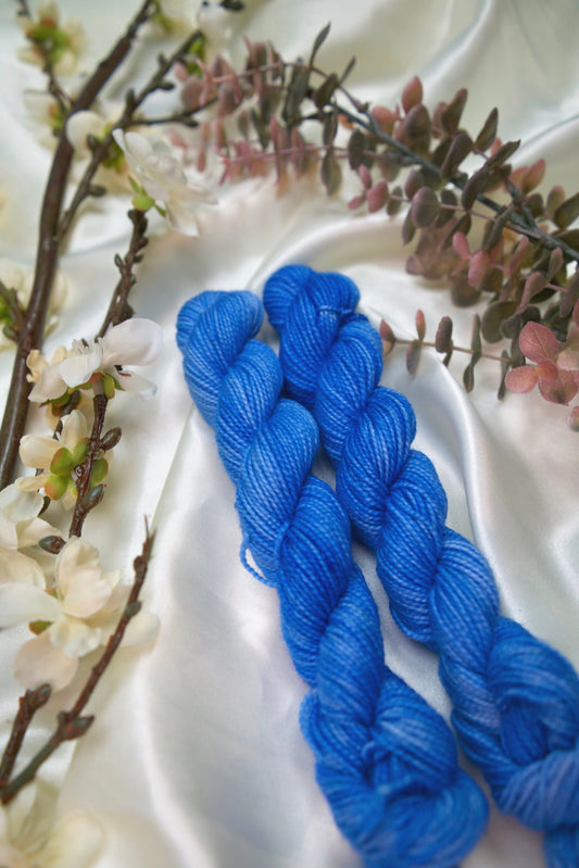 custom semisolid hand dyed yarn with bright sky blue and cornflower blue on nylon superwash sock yarn