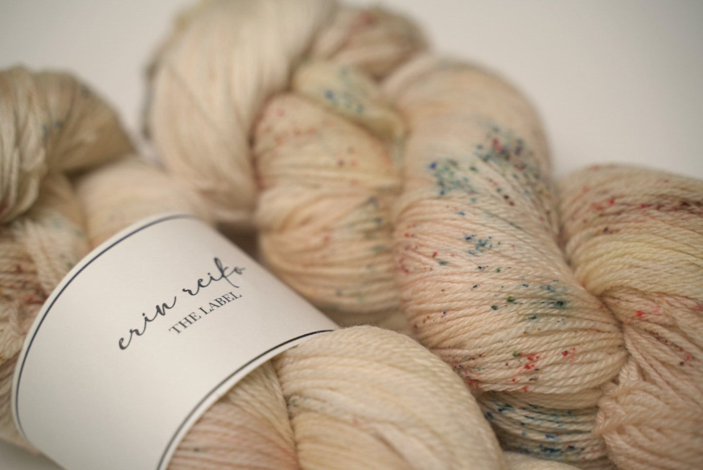 custom variegated hand dyed yarn with soft browns and creamy gold with sage green and mocha brown speckles on superwash fingering weight yarn