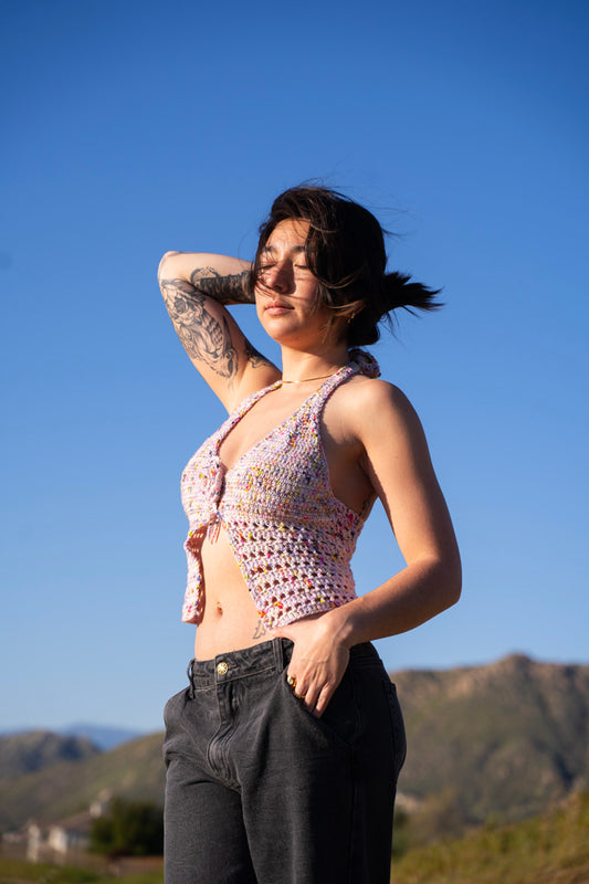 erin wearing a lilac colored crochet halter top, featuring triangle cups, mesh detailing and a crochet flower