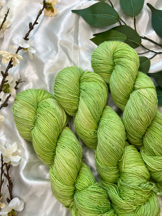 yellow toned green semi solid hand dyed yarn on linen sock fiber