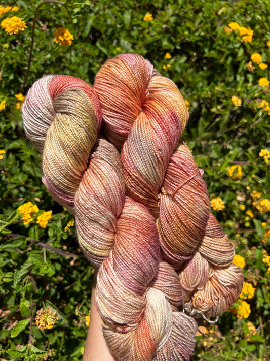 custom mauve, burgundy, gold and brown variegated hand dyed yarn on nylon superwash sock weight