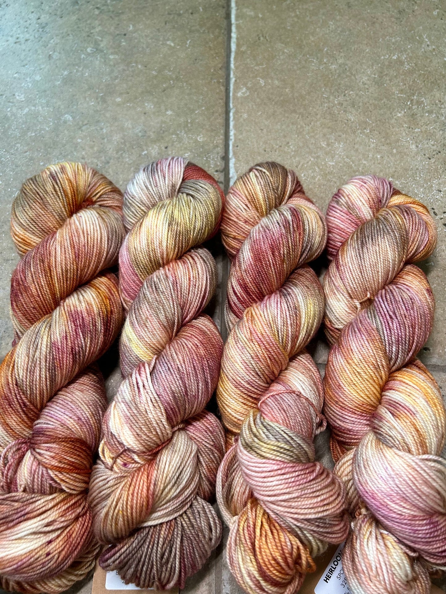 custom mauve, burgundy, gold and brown variegated hand dyed yarn on nylon superwash sock weight