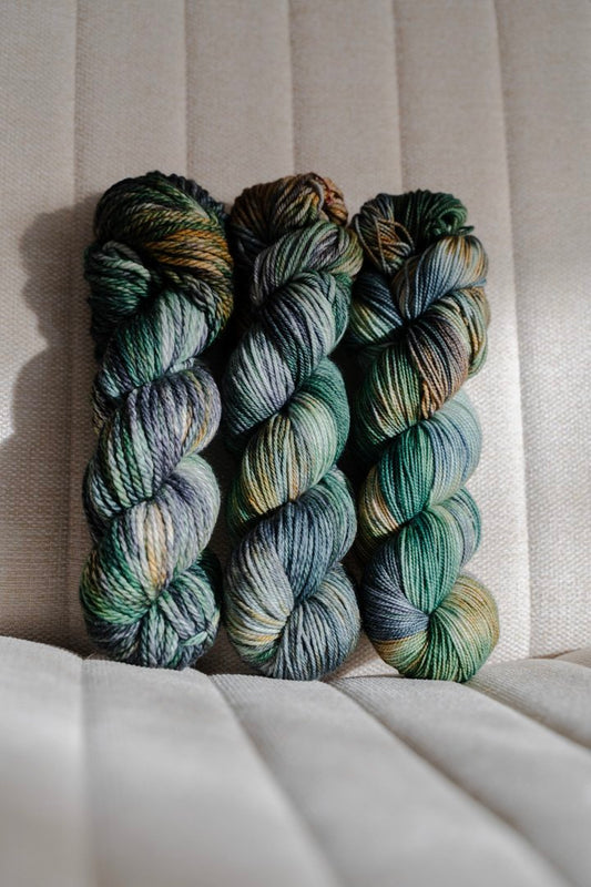 custom emerald green, forest green, gold, black, teal variegated hand dyed yarn on superwash nylon sock weight