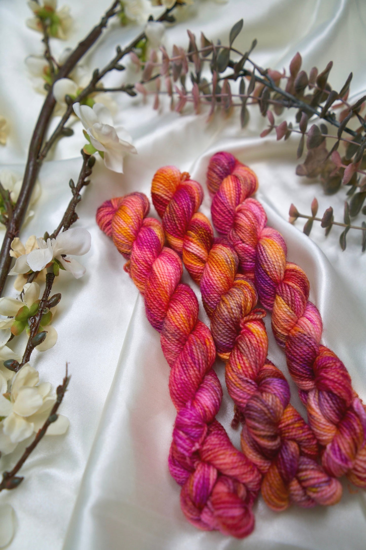 custom magenta, purple, orange, and
soft pink variegated hand dyed yarn on nylon superwash sock weight