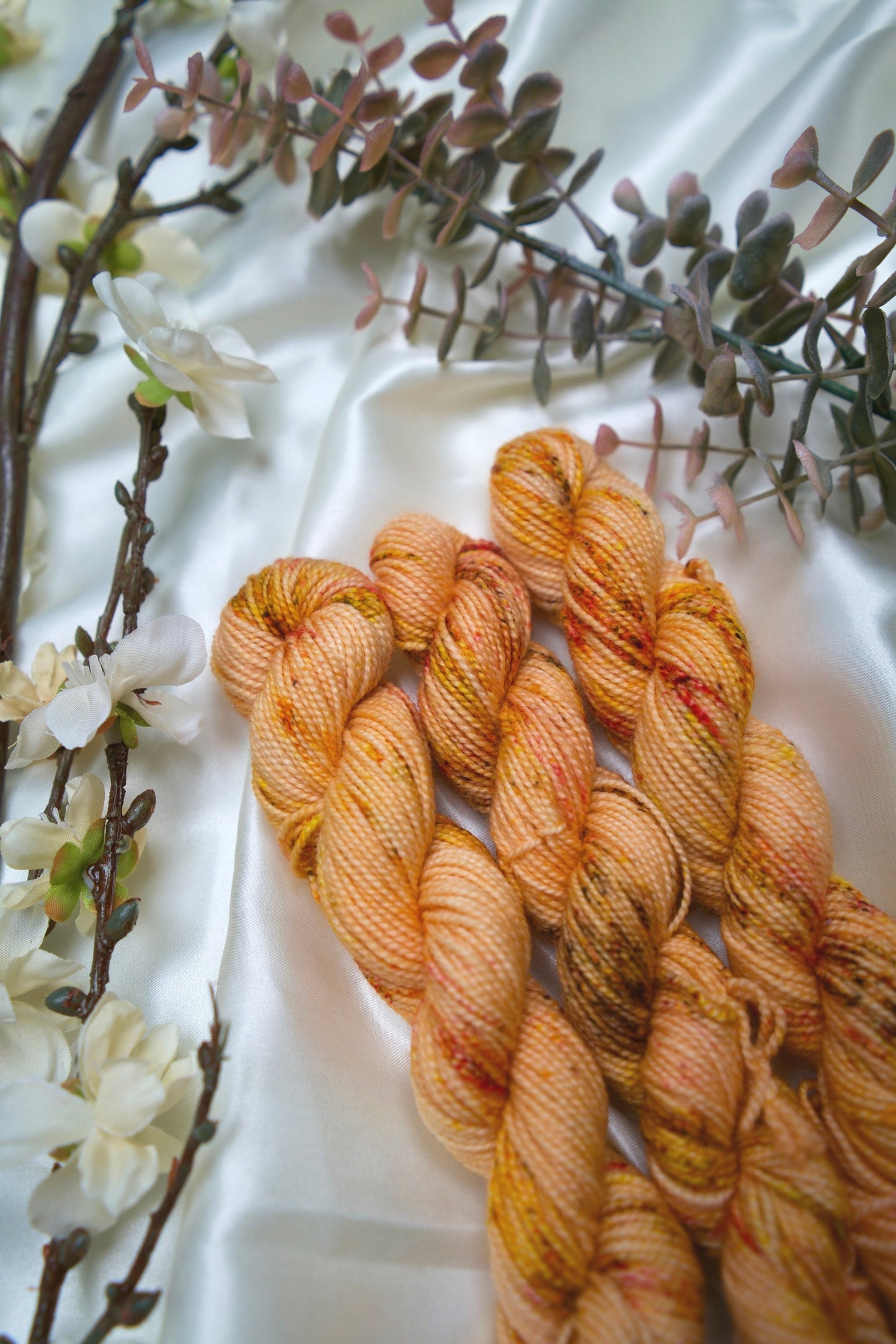 custom peach and cream orange variegated hand dyed yarn with brown, yellow and gold speckles on nylon superwash sock weight