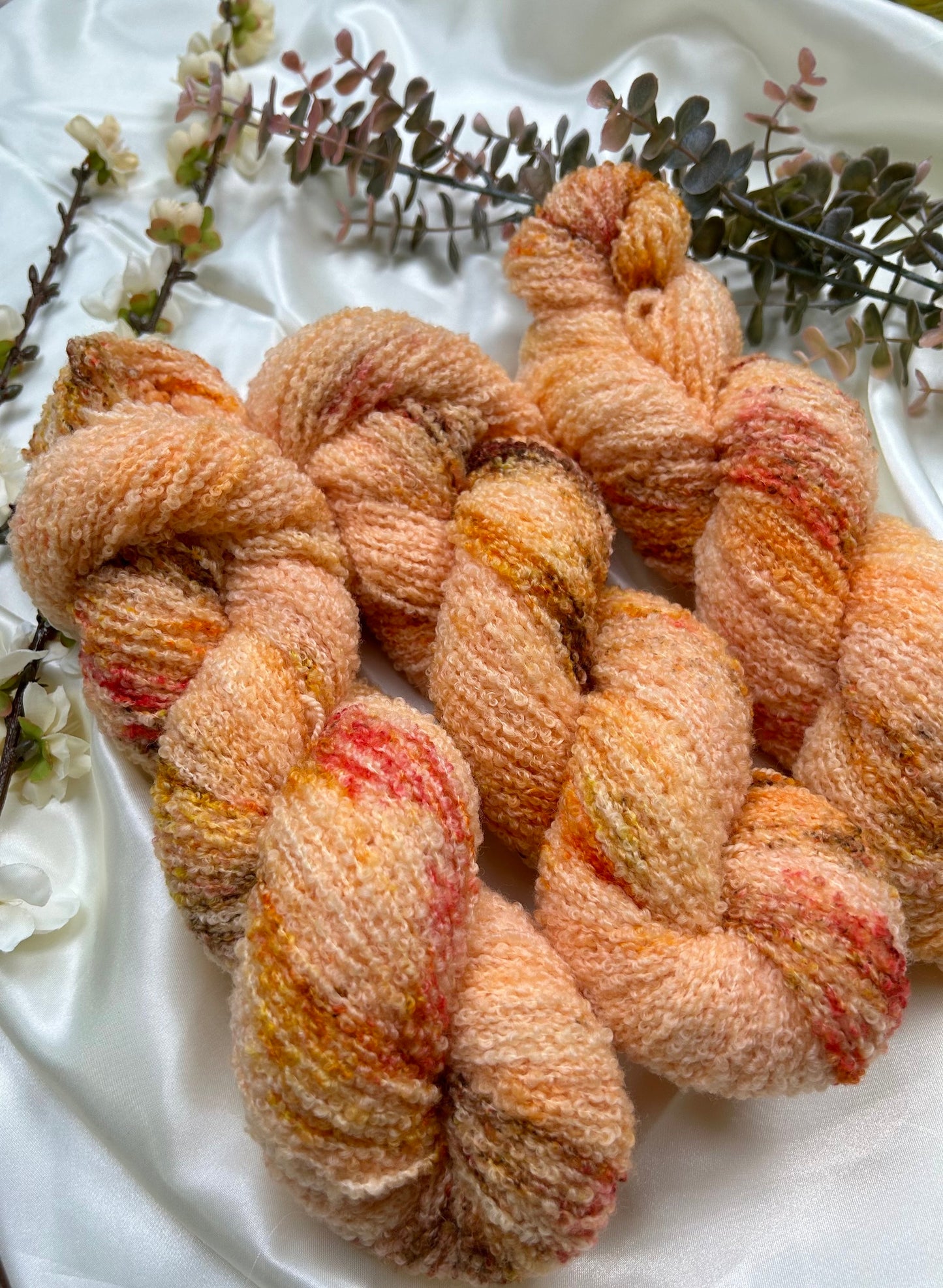 custom peach and cream orange variegated hand dyed yarn with brown, yellow and gold speckles on nylon superwash merino boucle yarn