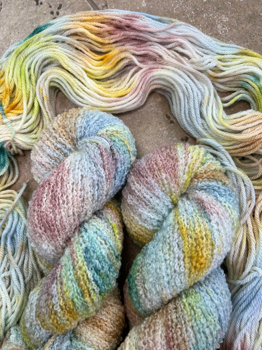 custom steel blue, cream, mauve, gold, hazel brown and lime green variegated hand dyed yarn with teal on superwash boucle yarn