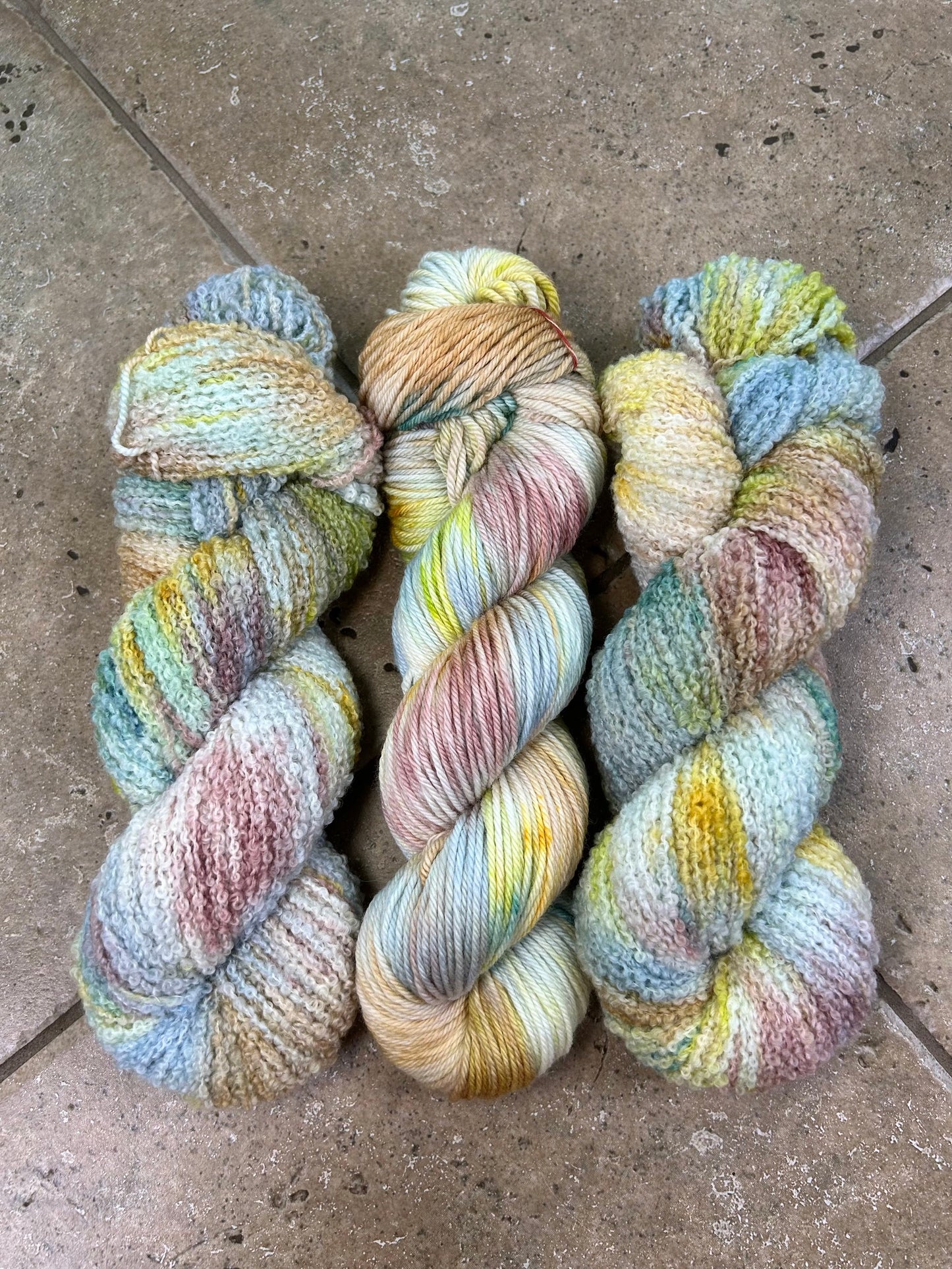 custom steel blue, cream, mauve, gold, hazel brown and lime green variegated hand dyed yarn with teal on superwash boucle yarn and superwash merino dk weight