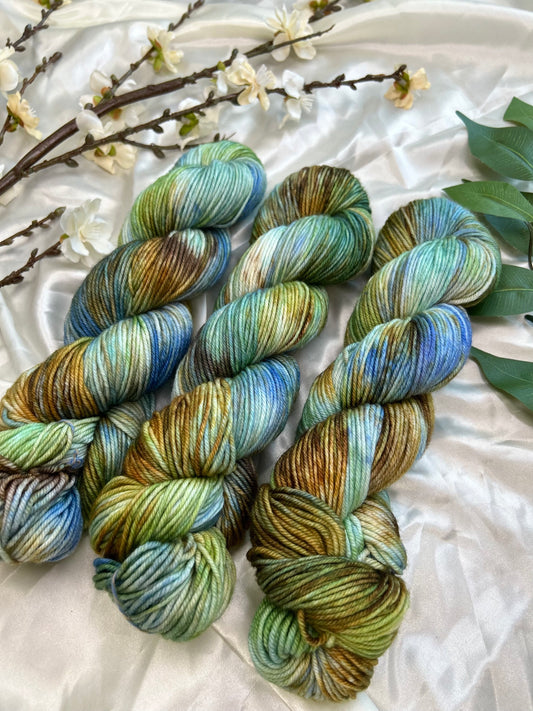 custom bright blue, green, cornflower blue, tan, brown variegated hand dyed yarn on superwash merino dk weight