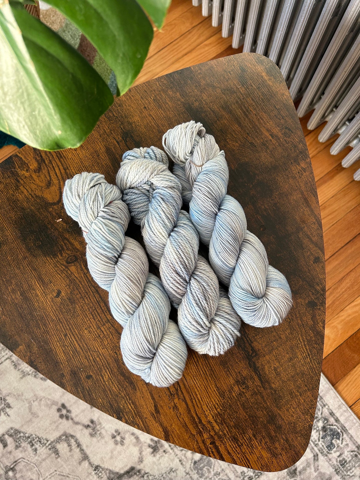 custom light blue, bright blue, soft tan, grey variegated hand dyed yarn on nylon superwash merino sock weight