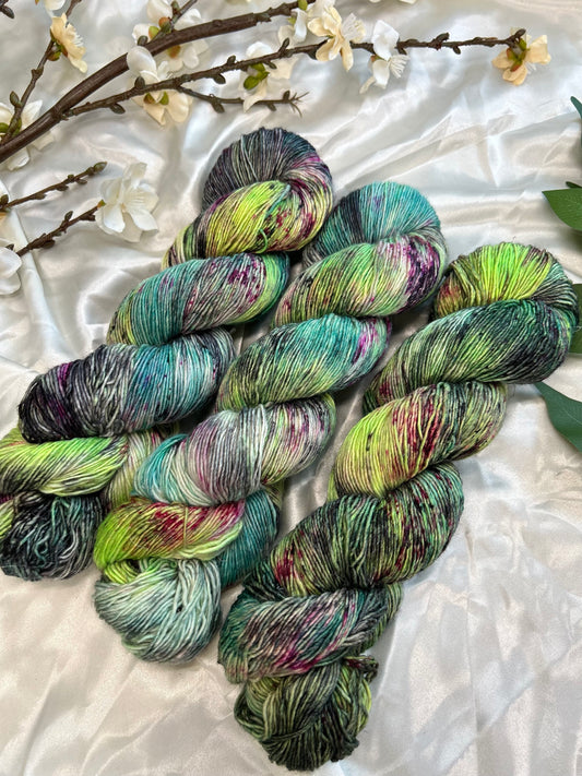 custom neon green, aqua, teal, black variegated hand dyed yarn with magenta and cherry red speckles on nylon superwash merino sock weight and linen sock