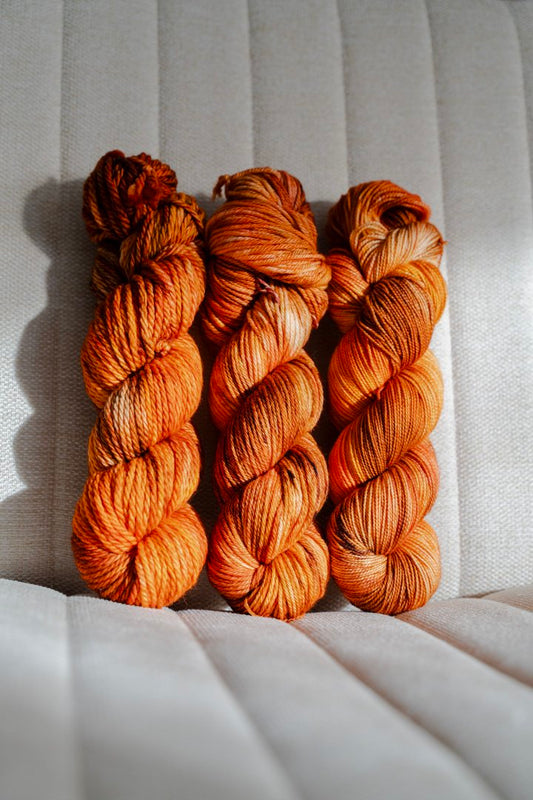 custom saffron, orange, cocoa brown, gold variegated hand dyed yarn on nylon superwash merino sock weight