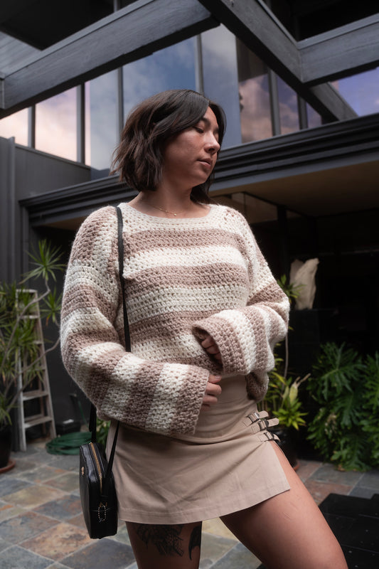 erin wearing a fluffy soft striped crochet sweater with crew neckline and tapered sleeves