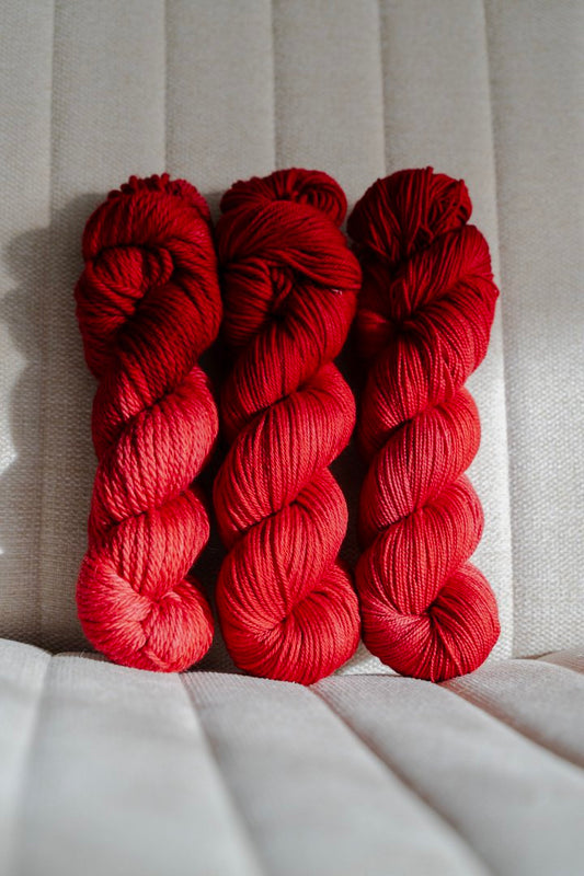 custom medium toned cherry red semisolid hand dyed yarn on nylon superwash sock yarn