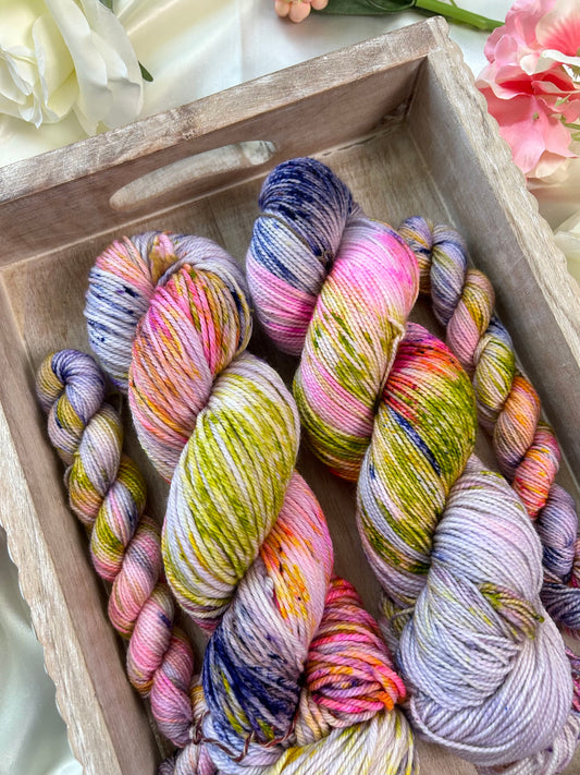 custom lilac and purple variegated hand dyed yarn with bright pink, lime green speckles on nylon superwash sock weight and dk weight