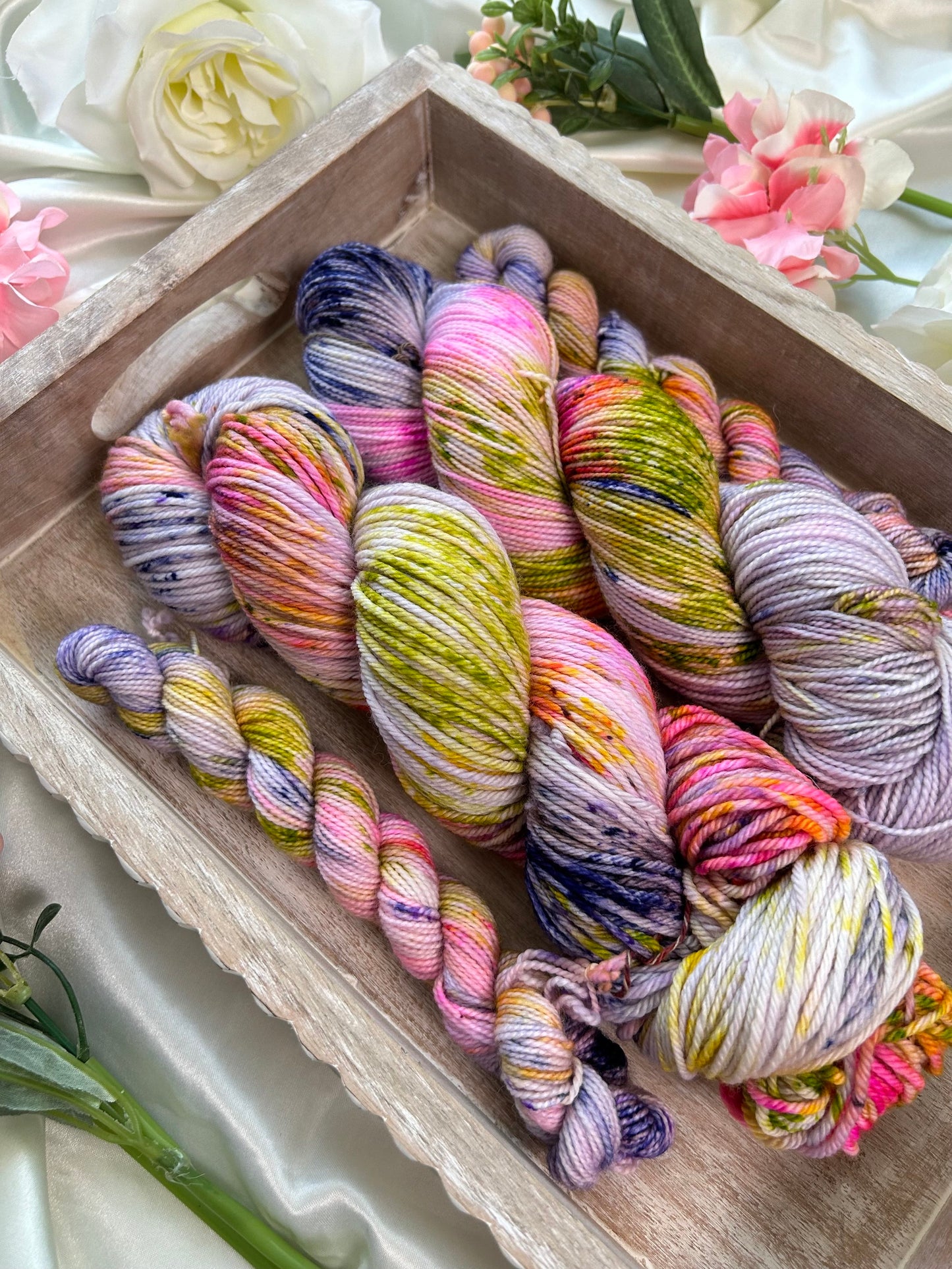 custom lilac and purple variegated hand dyed yarn with bright pink, lime green speckles on nylon superwash sock weight and dk weight