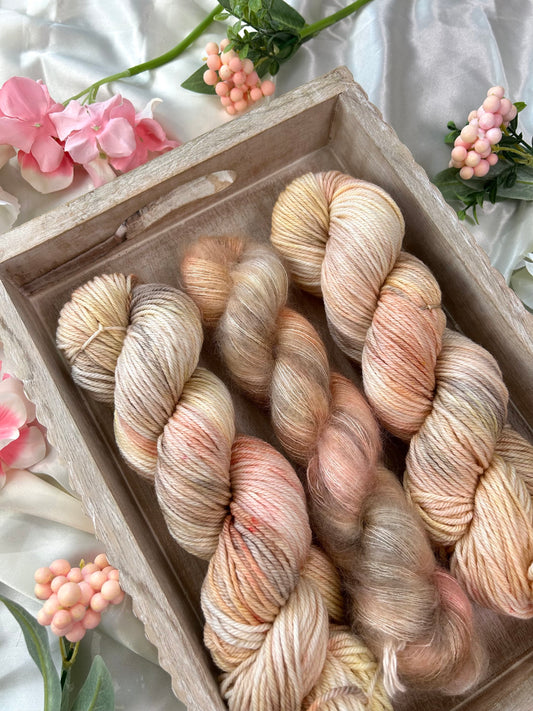 custom cream, salmon pink, light yellow variegated hand dyed yarn on superwash merino dk weight and silk mohair weight 