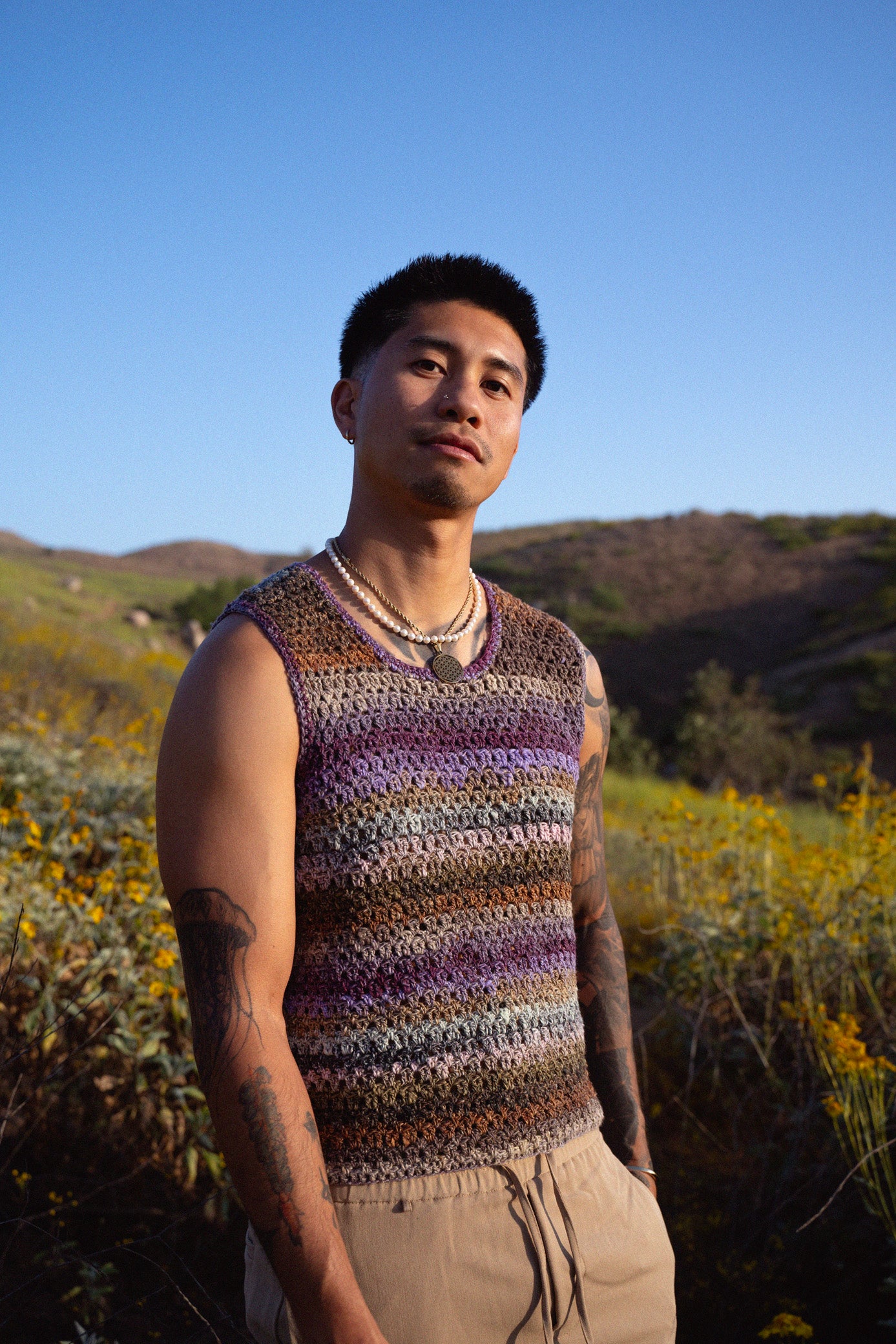 Jordan wearing a colorful crochet tank top with a textured mesh stitch.