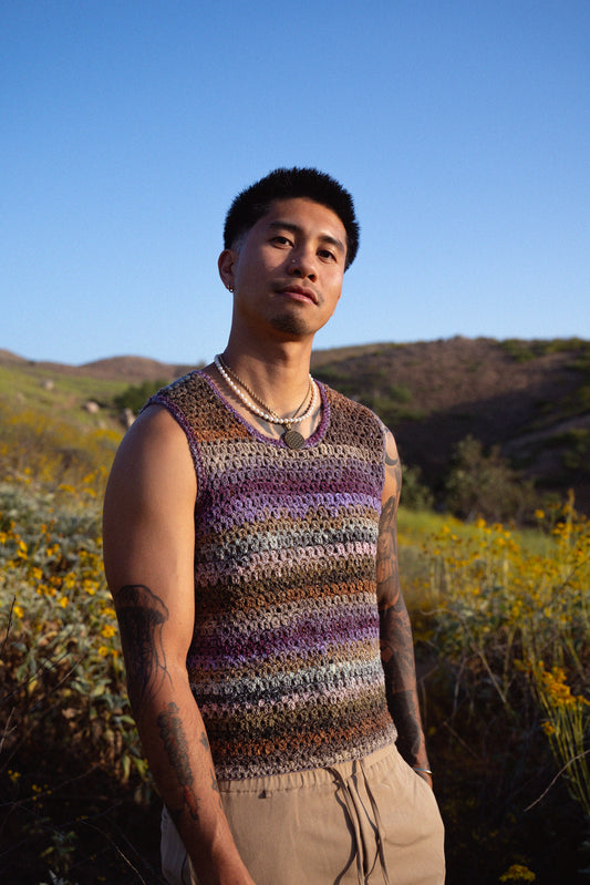 Jordan wearing a colorful crochet tank top with a textured mesh stitch.