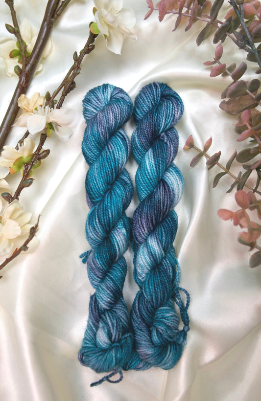 custom variegated hand dyed yarn with teal, deep blue and white on nylon superwash sock weight