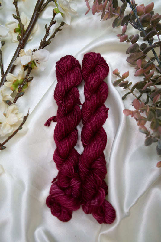 custom semisolid hand dyed yarn with deep burgundy and merlot on nylon superwash sock yarn