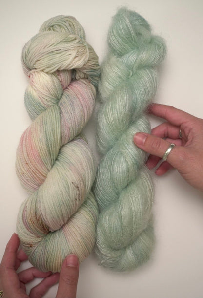 buddha hand dyed yarn colorway on mohair paired next to garden party hand dyed yarn on superwash fingering weight