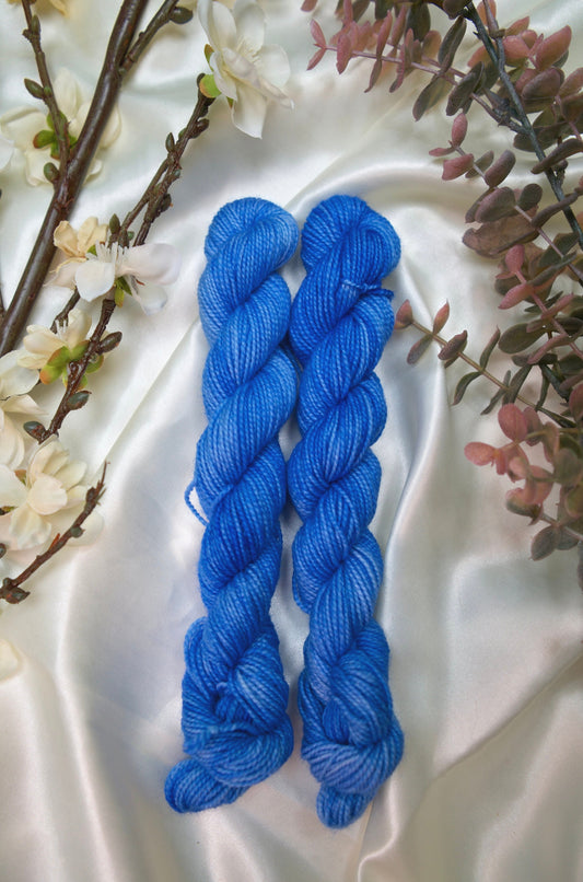 custom semisolid hand dyed yarn with bright sky blue and cornflower blue on nylon superwash sock yarn