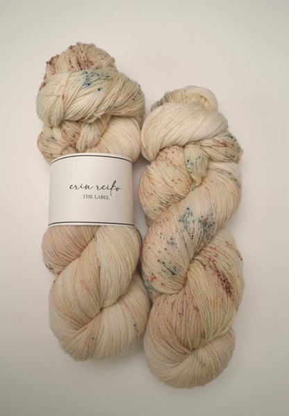 custom variegated hand dyed yarn with soft browns and creamy gold with sage green and mocha brown speckles on superwash fingering weight yarn