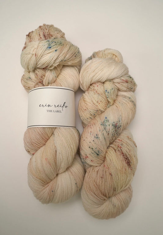 custom variegated hand dyed yarn with soft browns and creamy gold with sage green and mocha brown speckles on superwash fingering weight yarn