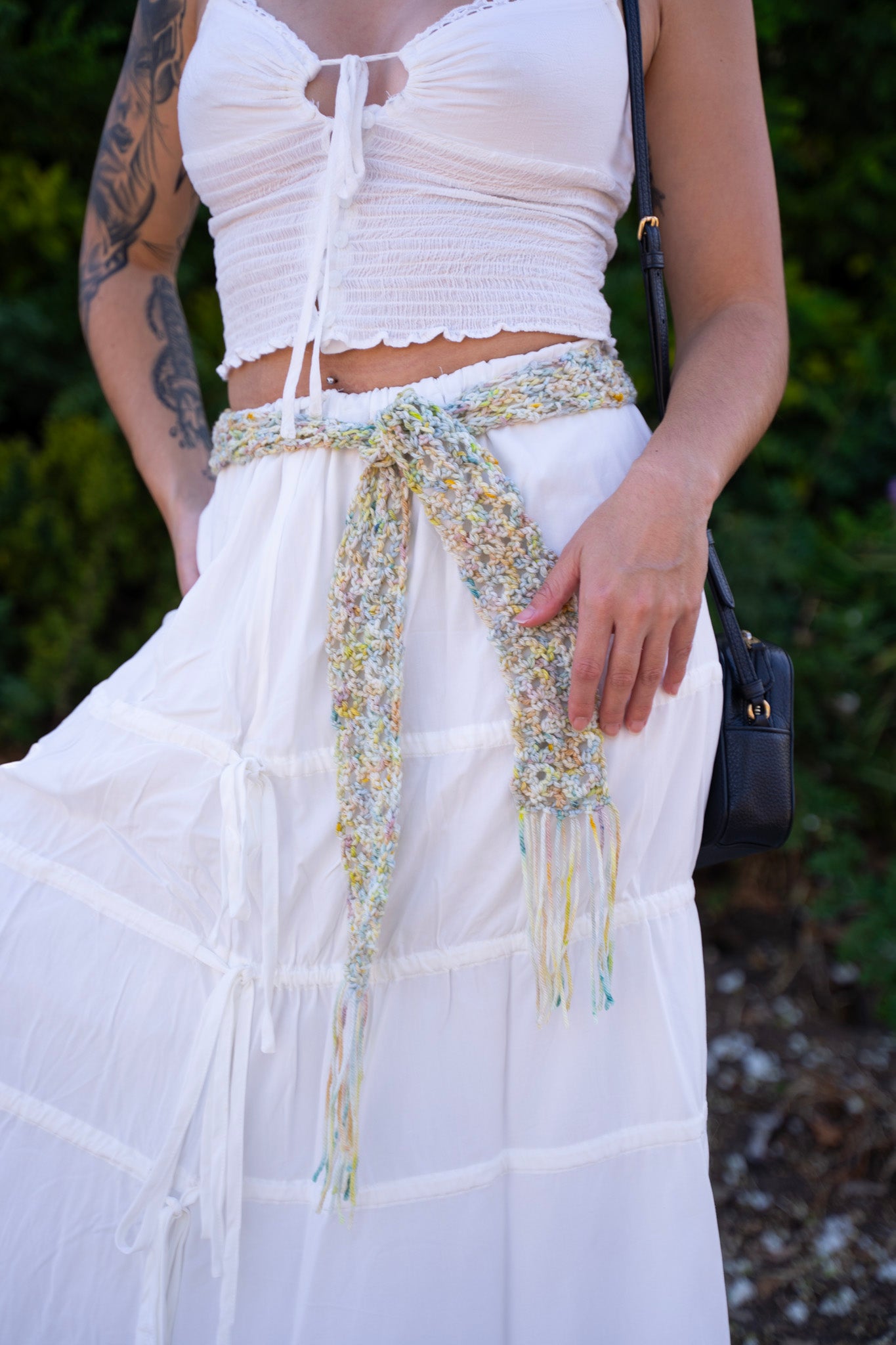 erin wearing a unique lace crochet accessory as a belt, made with variegated hand dyed yarn