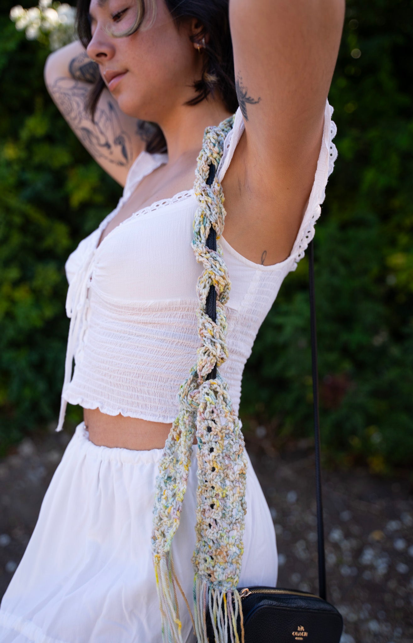 erin wearing a unique lace crochet accessory as a purse scarf, made with variegated hand dyed yarn