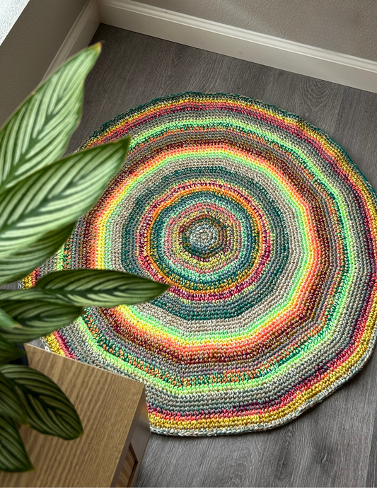 colorful striped crochet rug designed in a circle formation