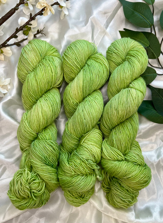 yellow toned green semi solid hand dyed yarn  on linen sock fiber