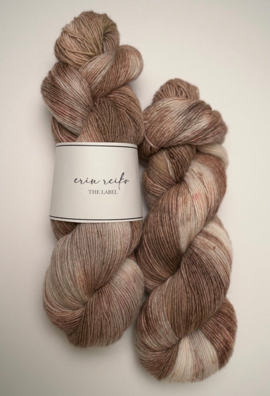 custom variegated hand dyed yarn with cream, brown and tan with light brown speckles on superwash merino fingering weight