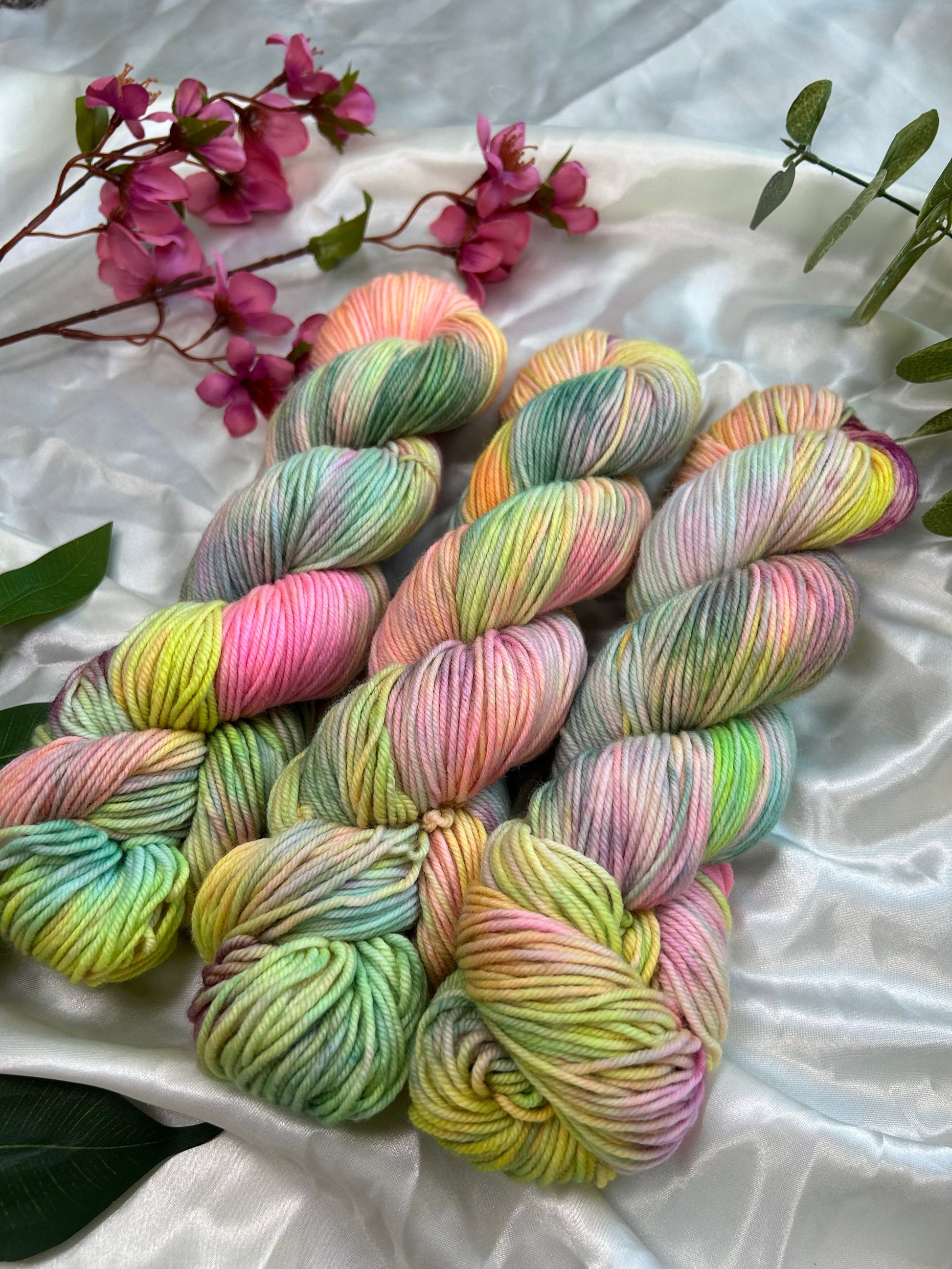 custom pastel rainbow hand dyed yarn with neon pinks, blues, teals and yellow on  superwash merino dk weight