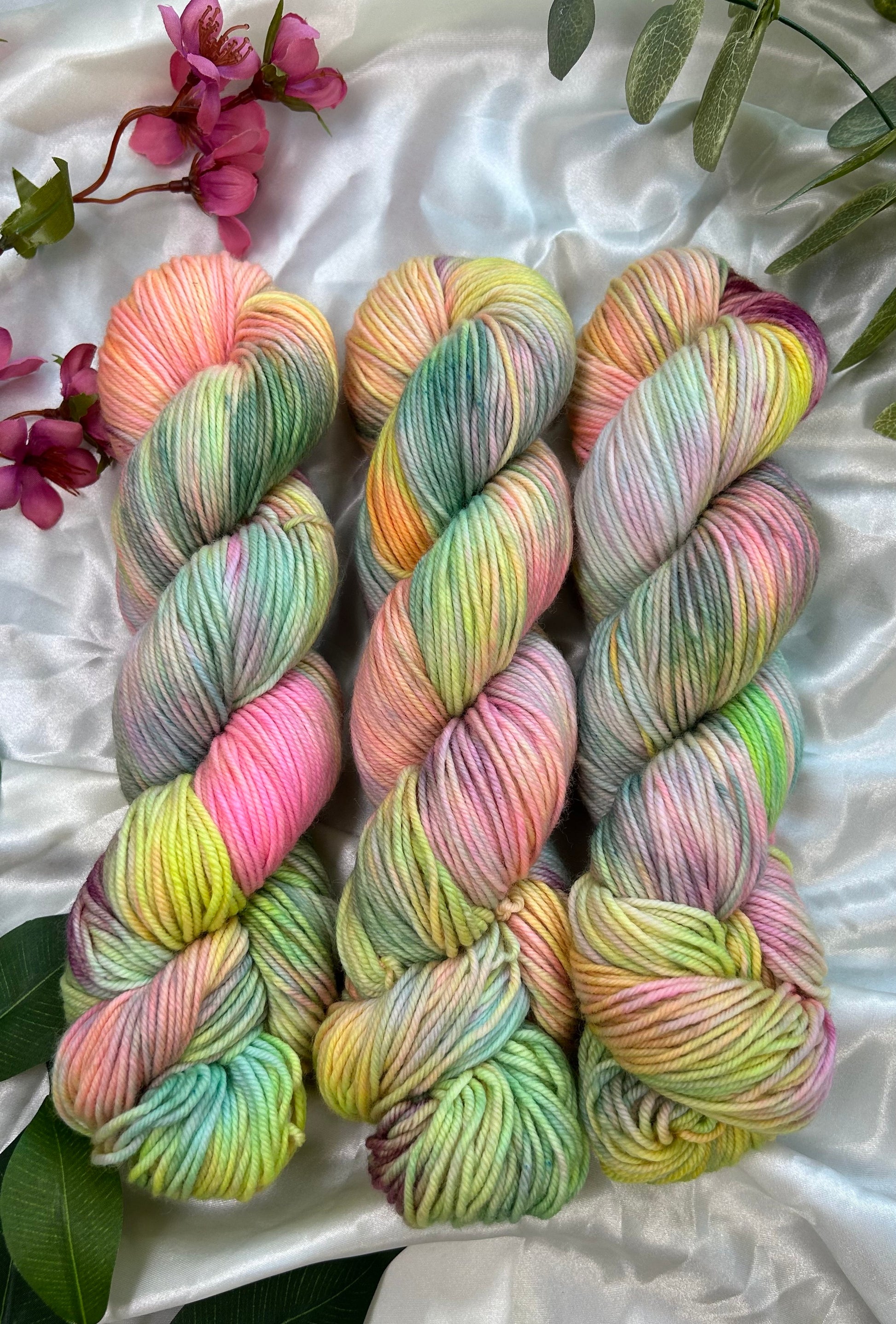 custom pastel rainbow hand dyed yarn with neon pinks, blues, teals and yellow on  superwash merino dk weight