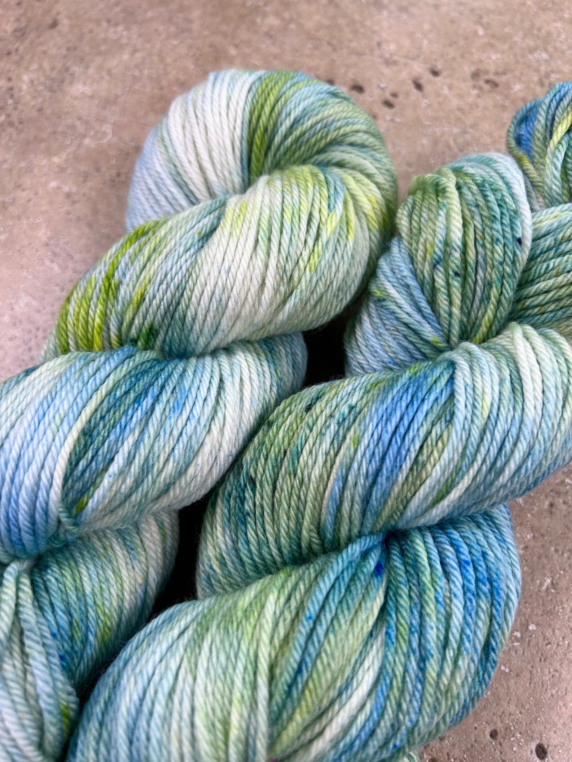 custom ocean blue, lime green and seafoam green variegated hand dyed yarn  on superwash merino dk weight