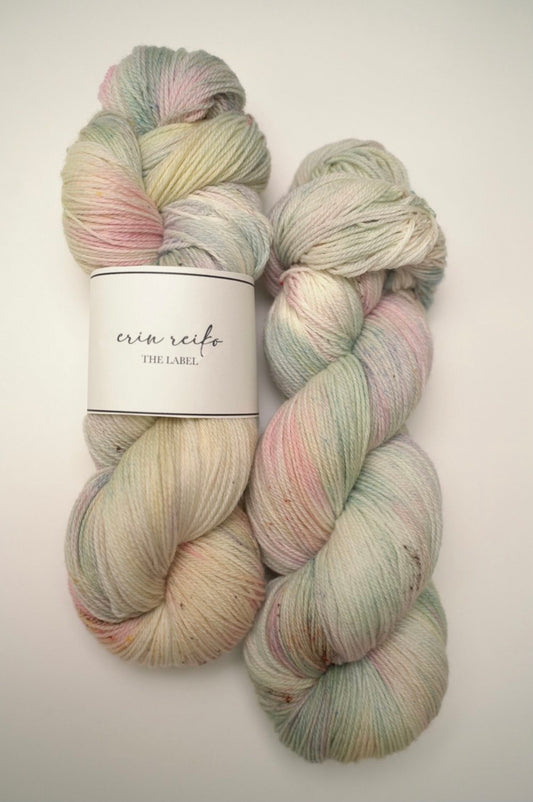 custom mint, sage green, flamingo pink, pastel yellow variegated hand dyed yarn with light cocoa brown speckles on superwash merino fingering weight