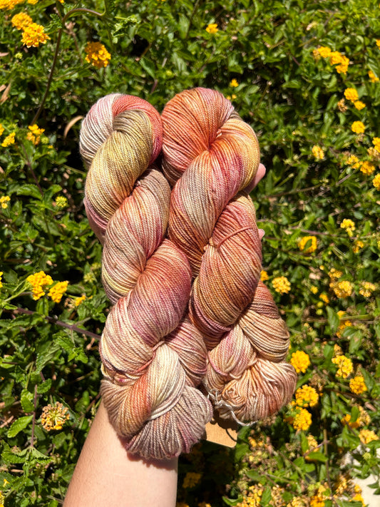 custom mauve, burgundy, gold and brown variegated hand dyed yarn on nylon superwash sock weight