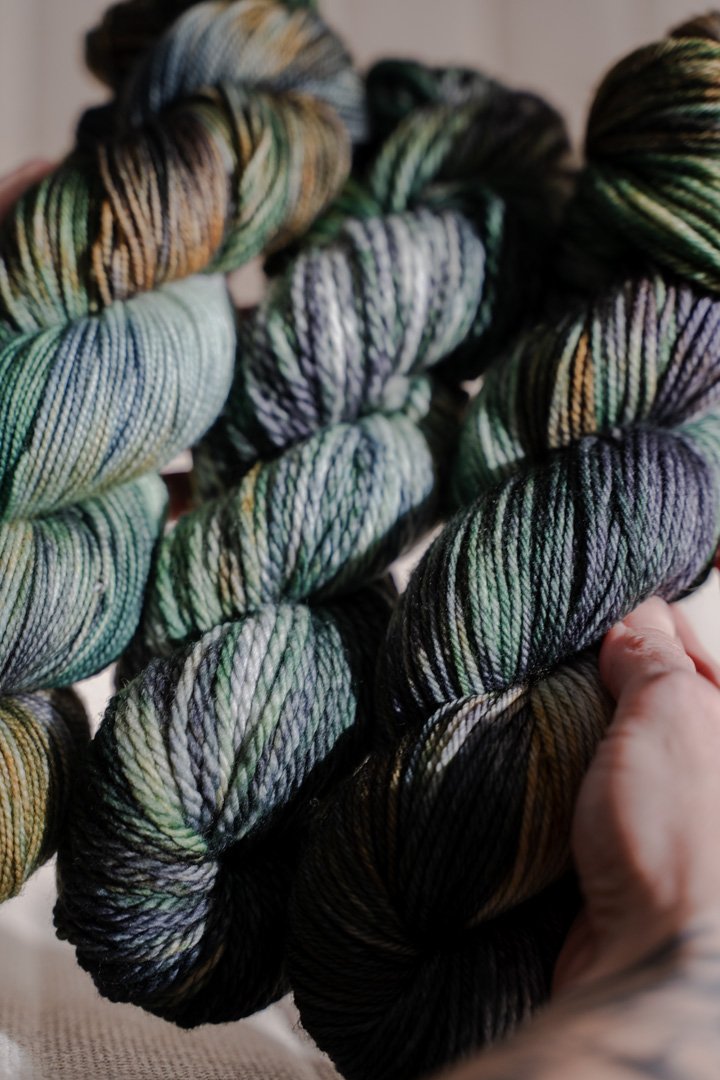 custom emerald green, forest green, gold, black, teal variegated hand dyed yarn on superwash nylon sock weight