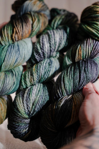 custom emerald green, forest green, gold, black, teal variegated hand dyed yarn on superwash nylon sock weight
