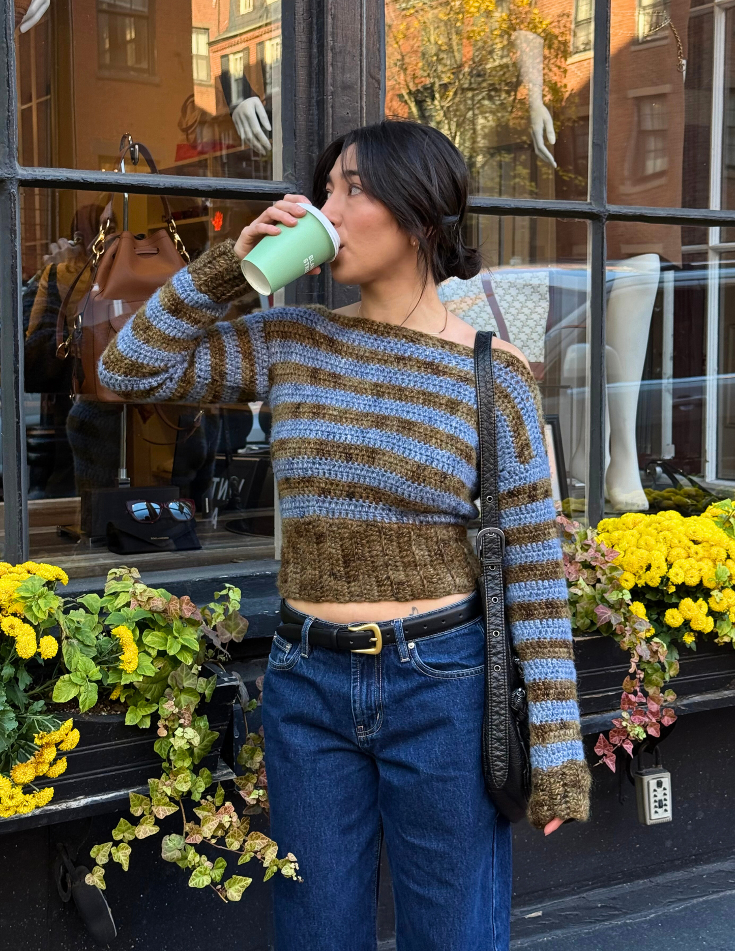 erin wearing striped long sleeve slouchy blouse in front of store window