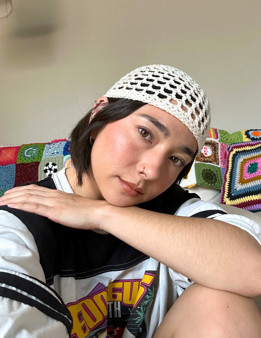 Erin wearing the meshi skull cap hat featuring an open mesh stitch and tight fit