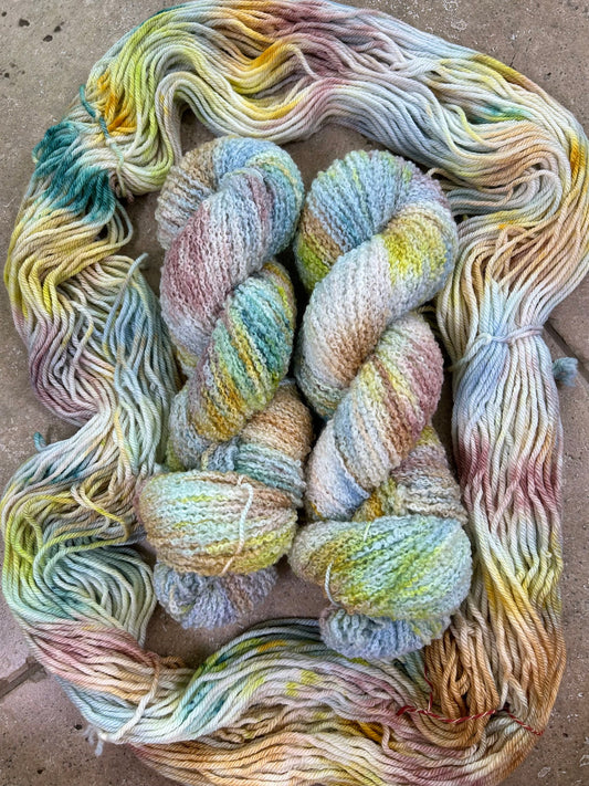 custom steel blue, cream, mauve, gold, hazel brown and lime green variegated hand dyed yarn with teal on superwash boucle yarn