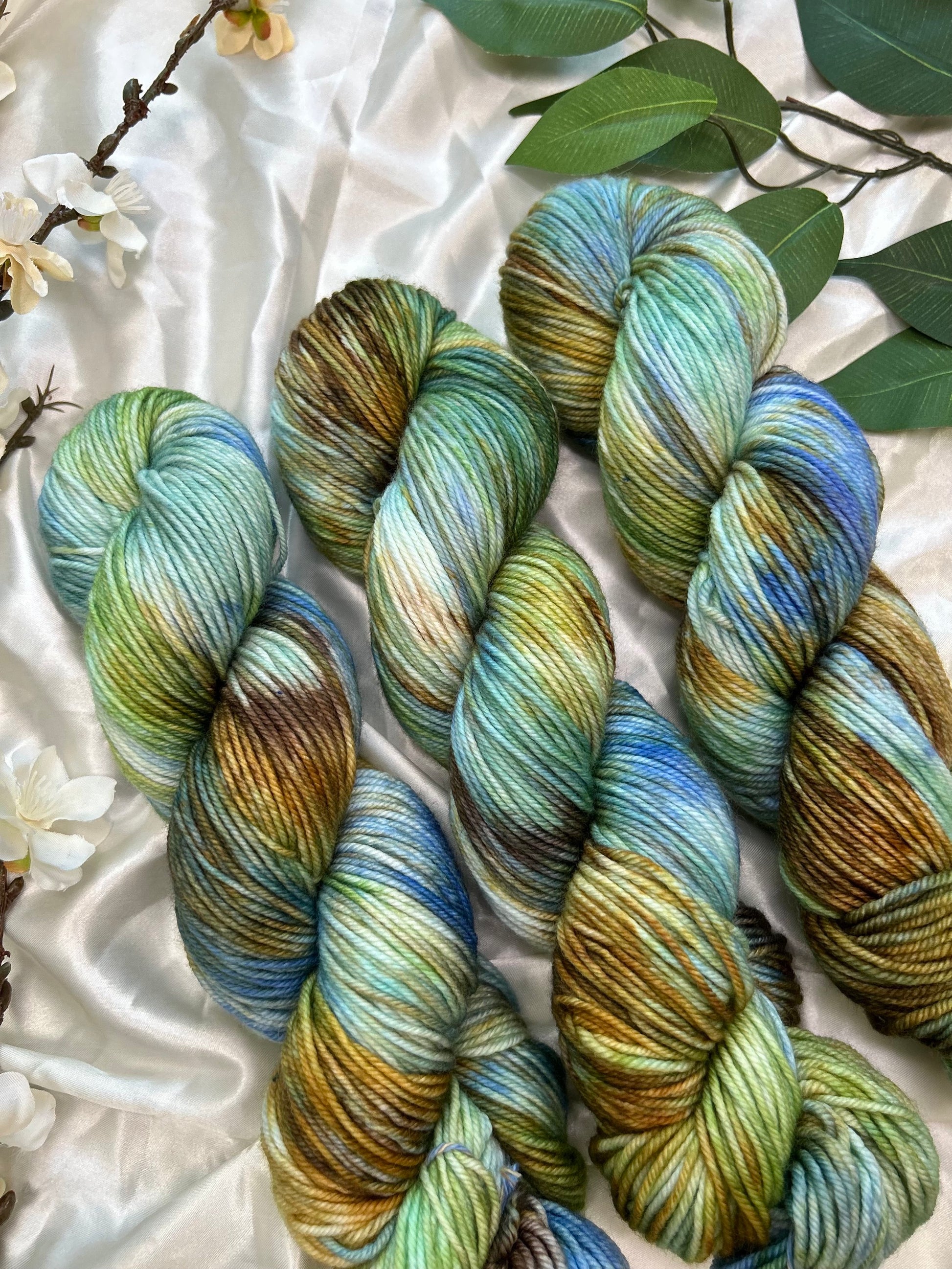 custom bright blue, green, cornflower blue, tan, brown variegated hand dyed yarn on superwash merino dk weight