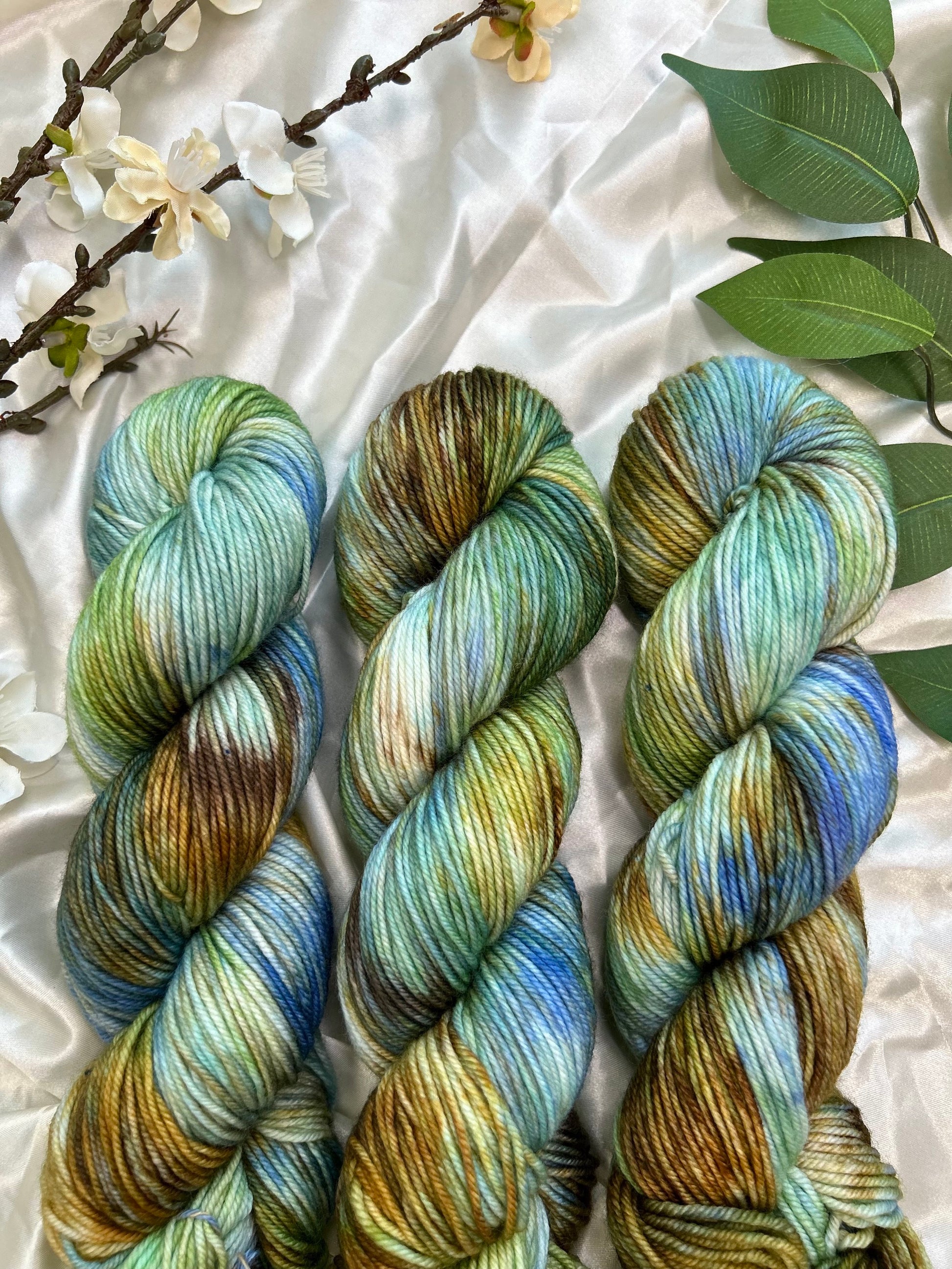 custom bright blue, green, cornflower blue, tan, brown variegated hand dyed yarn on superwash merino dk weight